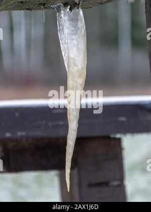 picture with icicle, icicle formed under a wooden table Stock Photo