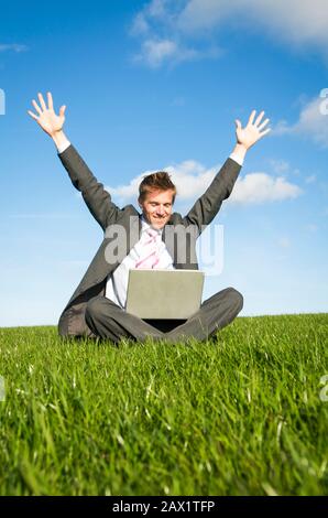 Excited businessman celebrating success with his arms raised up ...