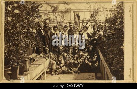 1863 , 23 march , WASHINGTON , DC , USA : Indian delegation in the White House Conservatory during the Civil War, with J.G. Nicolay ,  President Abraham Lincoln 's secretary, standing in center back row.  The U.S.A. President ABRAHAM LINCOLN ( 1809 - 1865 ). Photograph of the Southern Plains delegation, taken in the White House Conservatory on March 27, 1863. The interpreter William Simpson Smith and the agent Samuel G. Colley are standing at the left of the group; the white woman standing at the far right is often identified as Mary Todd Lincoln. The Indians in the front row are, left to righ Stock Photo