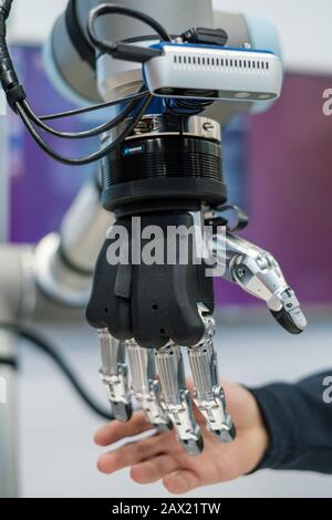 Human hand and robotic arm Stock Photo