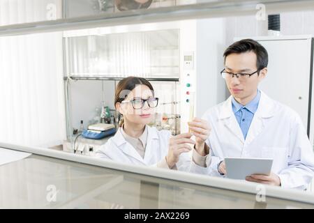 Two promising scientists developing new medicament in modern laboratory, horizontal shot Stock Photo