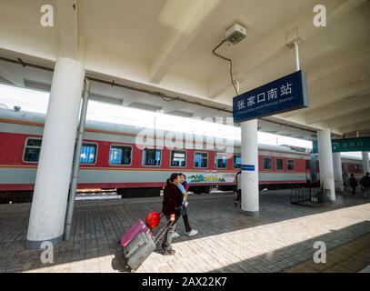 Chinese female passengers with luggage on Intercity Zhangjiakou South railway station platform, Hebei Province, China Stock Photo