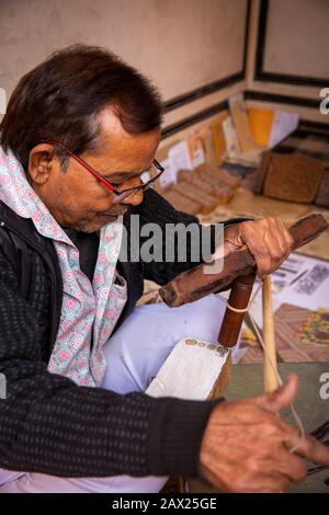 India, Rajasthan, Jaipur, Amber, Anokhi Museum of Hand Printing, craftsman carving ajrakh wooden printing block with traditional bow drill Stock Photo