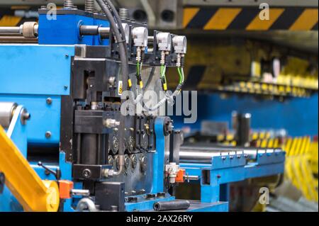 Stamping metal sheet by pressing machine, cnc control metal pressing machine, high precision and high accuracy metal pressing and punching machine . Stock Photo