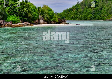 Horizontal view of paradise beach of uninhabited island with boat, Therese Island, Mahe, Seychelles. Stock Photo