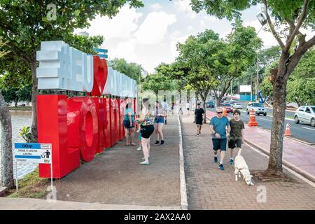 Londrina PR, Brazil - December 23, 2019: People walking at Higienopolis avenue and the christmas totem in front of Igapo Lake. I Love The Christmas of Stock Photo