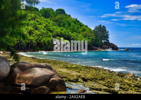 Ocean waves and granite rocks - Petite Police Beach Mahe Island, Seychelles. Stock Photo