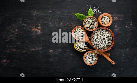 Sesame. Set of black and white sesame seeds. On a black background. Top view. Free copy space. Stock Photo