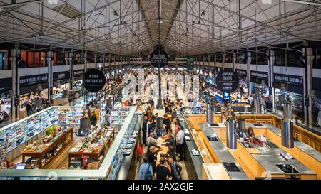 People at the Time Out Market Lisboa, a food hall and major touristic attraction located in the Mercado da Ribeira at Cais do Sodre, Lisbon, Portugal. Stock Photo