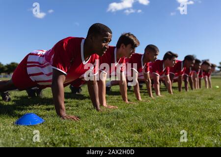 Rugby team doing push-ups Stock Photo