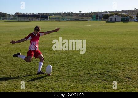 Rugby player shooting in the ball Stock Photo