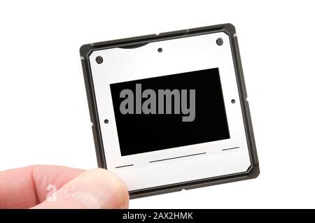 Photo slide in hand isolated on white background.