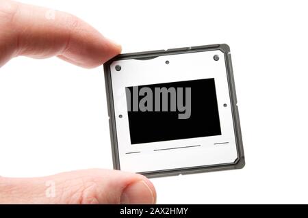 Photo slide in hand isolated on white background.