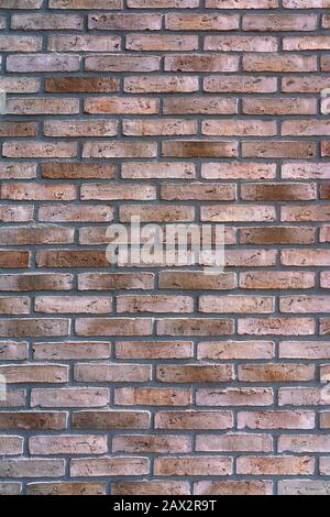New brown-patterned brick facade. Background Stock Photo