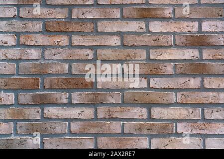 New brown-patterned brick facade. Background Stock Photo