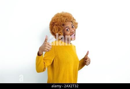 Portrait of a smiling African American young woman showing thumbs up. Stock Photo