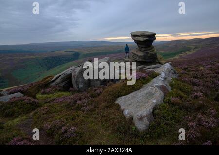 Man taking in the sunset view at the Salt Cellar on Derwent Edge Stock Photo