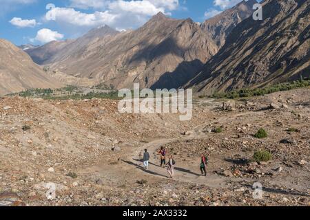 Foreign tourists and locals walking in the mountains of Yasin Valley, Gilgit Baltistan, northern Pakistan Stock Photo