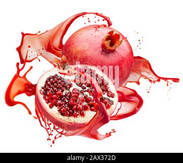 pomegranates in red juice splash isolated on a white background. Stock Photo