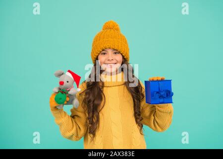 happy new 2020 year. cute santa mice toy gift. small girl hold mouse toy and present box. child knitted clothes play with toy rat. toy shop for kids. christmas is here. xmas favorite winter holiday. Stock Photo