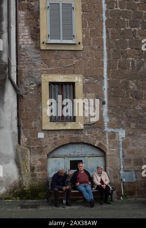 Three seniors sitting on a bench in Vetralla Italy Stock Photo