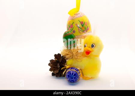 Funny Easter eggs and yellow chicks and Easter bunnies with a white and yellow background, to be used as a postcard or wallpaper Stock Photo