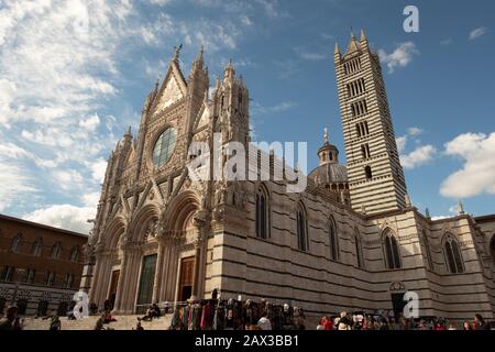 Romanesque-Gothic cathedral with mosaics 13th-century famous facade of marble stripes in symbolic black and white colors of Sienne Tuscany Italy Stock Photo