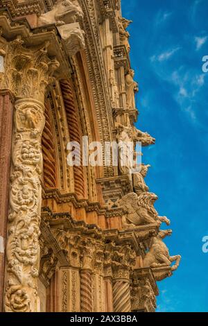Duomo di Siena with detailed Gargoyle sculptures on the façade. Siena Cathedral is a medieval church in Siena, Italy Stock Photo
