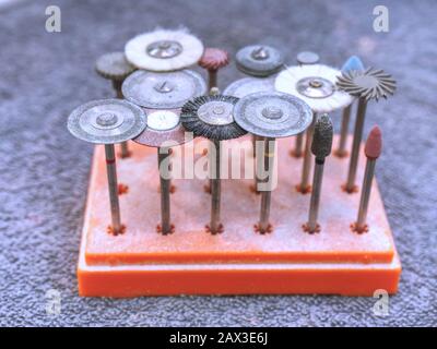 Dental tools for milling, cutting or polishing by dental carbide burs.  Professional equipment for production of dental implant or all-ceramic crown w Stock Photo