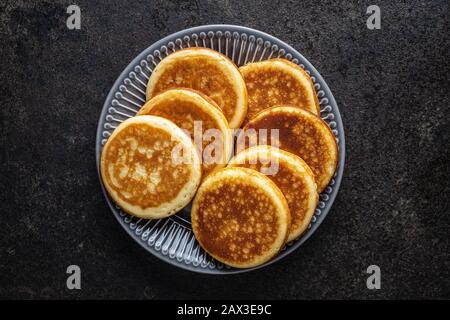 Sweet homemade pancakes on old kitchen table. Stock Photo