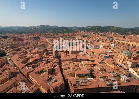 Aerial cityscape of Bologna, Italy with a view from the top of Asinelli tower to Basilica di San Petronio and Santa Maria della Vita church and green Stock Photo