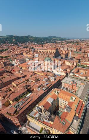 Aerial cityscape of Bologna, Italy with a view from the top of Asinelli tower to Basilica di San Petronio and Santa Maria della Vita church and green Stock Photo