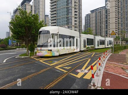 A tram travels near Pazhou Bridge South station on the Haizhu tram system in Guangzhou, China Stock Photo