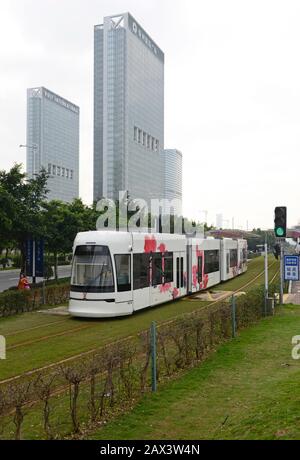 A tram travels near Pazhou Bridge South station on the Haizhu tram system in Guangzhou, China Stock Photo