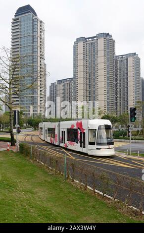 A tram travels near Pazhou Bridge South station on the Haizhu tram system in Guangzhou, China Stock Photo