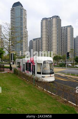 A tram travels near Pazhou Bridge South station on the Haizhu tram system in Guangzhou, China Stock Photo