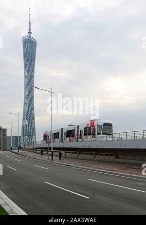 A tram travels on the Haizhu tram line near the Canton Tower in eastern Guangzhou, southern China Stock Photo