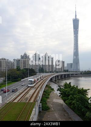 A tram travels on the Haizhu tram line near the Canton Tower in eastern Guangzhou, southern China Stock Photo