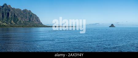 Panorama of Mokoli'i Island (previously known as the outdated term 'Chinaman's Hat') off the coastline of Oahu in Hawaii from the Waiahole Beach Park Stock Photo