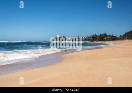 Almost deserted sandy beach at Sunset Beach park near Banzai Pipeline on north coast of Oahu, Hawaii Stock Photo