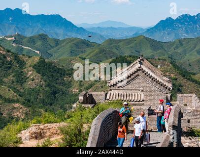 Asian man flying a drone at Small Jinshan Tower, Jinshanling Great Wall of China, Asia Stock Photo