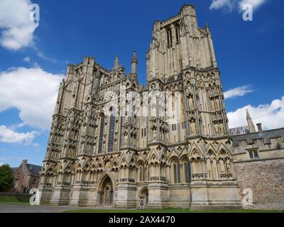 An external view of the gothic Wells Cathedral in Somerset, UK, seat of the Bishop of Bath and Wells showing the west front and tower Stock Photo