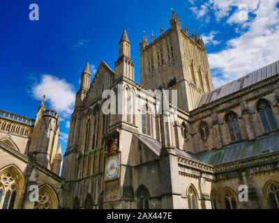 An external view of the gothic Wells Cathedral in Somerset, UK, seat of the Bishop of Bath and Wells showing the tower, nave and north transept Stock Photo