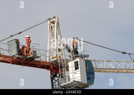 Dismantling a Construction sky crane from a new high rise multistory building site.  Gosford, New South Wales, Australia. Stock Photo