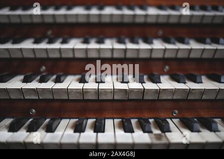 Keys on a big old brown church organ Stock Photo