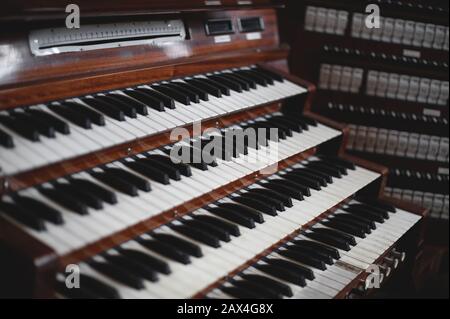 Keys and buttons on a big old brown church organ Stock Photo