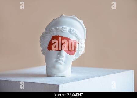 Plaster bust with red strip on the eyes Stock Photo