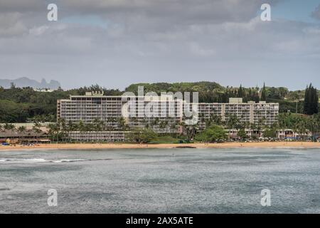 Nawiliwili, Kauai, Hawaii, USA. - January 17, 2020: Marriott Beach Resort buildings surrounded by green trees adjacent to the port. Gray ocean water u Stock Photo