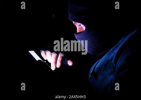 cyber hacker stealing data from smart phone at night  Stock Photo