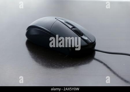 Photo of a computer mouse on a wooden table. Stock Photo